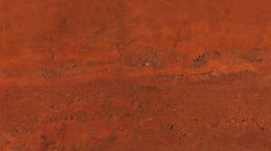Premium Persian Red Soraya travertine stone texture with deep terracotta hues and natural porous details for luxury architectural projects.